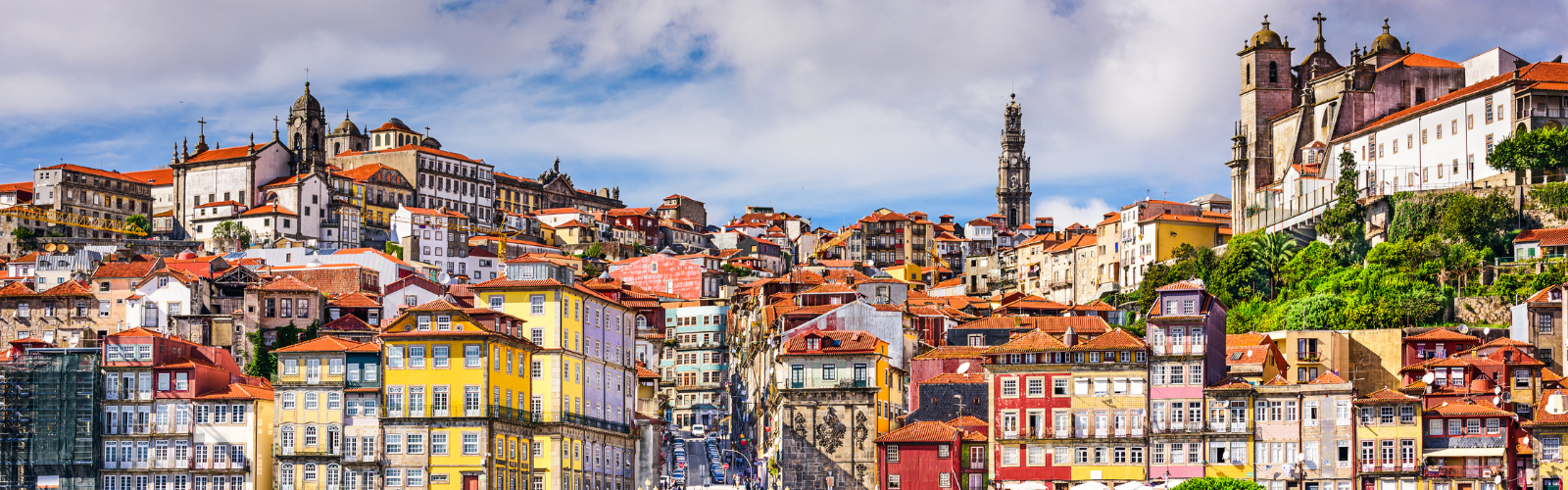 Brightly colored red-roofed buildings on a steep hillside.